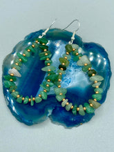 Load image into Gallery viewer, Elegant hoop earrings featuring natural green aventurine stone chips and gold-tinged glass beads. Measurements: 2" length and 1 1/2” in width