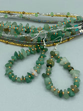 Load image into Gallery viewer, Elegant hoop earrings featuring natural green aventurine stone chips and gold-tinged glass beads. Measurements: 2" length and 1 1/2” in width