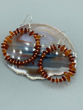 Load image into Gallery viewer, These hoop earrings feature natural amber stone chips and gold glass beads for an elegant, nature-inspired look. Measurements: 2" length and 2” in width
