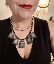 Load image into Gallery viewer, This eye-catching large trapezoid-shaped black lava stone wired pendant offers a lovely star-shaped charm design which gives the look of a night sky. Constructed of 3 strands, this statement piece exudes sophistication and charm. With matching earrings included, it is ideal for adding to your jewelry collection. Measurements: Necklace is is 15 1/2” adjustable up to 18"