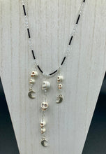 Load image into Gallery viewer, Massive beautiful bold cascade of skulls goth witchy necklace is the ultimate statement piece to add to your jewelry collection! Three strands full of howlite skull beads draping down with smiling crescent moon charms. Chingona, Cabrona, Latina Chicana, Goth, Vampire Goth, Dark Witchy Style. You can dress these up or down, it will definitely give your outfit a unique look.  Measurements: 17” adjustable up to 19" in length