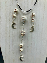 Load image into Gallery viewer, Massive beautiful bold cascade of skulls goth witchy necklace is the ultimate statement piece to add to your jewelry collection! Three strands full of howlite skull beads draping down with smiling crescent moon charms. Chingona, Cabrona, Latina Chicana, Goth, Vampire Goth, Dark Witchy Style. You can dress these up or down, it will definitely give your outfit a unique look.  Measurements: 17” adjustable up to 19" in length