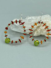 Load image into Gallery viewer, These Amber Stone Chip Beaded Hoop Earrings feature turquoise and gold glass beads, and a light green glass leaf charm with an iridescent shimmer finish with hints of gold, purple, blue, and pink. Measurements: 2" length