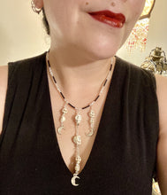 Load image into Gallery viewer, Massive beautiful bold cascade of skulls goth witchy necklace is the ultimate statement piece to add to your jewelry collection! Three strands full of howlite skull beads draping down with smiling crescent moon charms. Chingona, Cabrona, Latina Chicana, Goth, Vampire Goth, Dark Witchy Style. You can dress these up or down, it will definitely give your outfit a unique look.  Measurements: 17” adjustable up to 19" in length