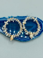 Load image into Gallery viewer, These beautiful white moon stone chip and gold glass beaded hoop earrings feature natural conch shells, perfect for a touch of nature-inspired masterful craftsmanship. A must-have accessory for those with a love of the outdoors, beach, and summertime. Measurements: 1 3/4" length