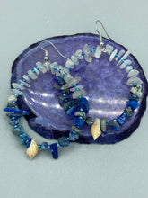 Load image into Gallery viewer, These earrings boast a beautiful combination of natural lapis and white moon stone chip stones, artfully inlaid with gold glass beads in a hoop formation. Dainty conch shells add a subtle touch of nature for a look that perfectly captures the beach vibes of summer. An ideal choice to complement any style. Measurements: 2 1/4" length