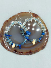 Load image into Gallery viewer, These earrings boast a beautiful combination of natural lapis and white moon stone chip stones, artfully inlaid with gold glass beads in a hoop formation. Dainty conch shells add a subtle touch of nature for a look that perfectly captures the beach vibes of summer. An ideal choice to complement any style. Measurements: 2 1/4" length