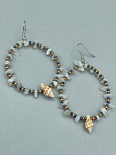Load image into Gallery viewer, Dainty conch shells and natural white moon stone chips, these dark silver and gold glass beaded hoop earrings are the perfect accessory for any nature-loving, beach-themed outfit. Their versatility allows them to easily complement any outfit. Measurements: 2 1/4" length