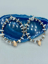 Load image into Gallery viewer, Dainty conch shells and natural white moon stone chips, these dark silver and gold glass beaded hoop earrings are the perfect accessory for any nature-loving, beach-themed outfit. Their versatility allows them to easily complement any outfit. Measurements: 2 1/4" length