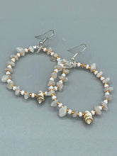 Load image into Gallery viewer, Delicate white moon stone chip and glass beaded hoop earrings featuring chic gold accents and tiny conch shells. Perfect for nature lovers, these boho-inspired summer earrings will add a subtle sophistication to any outfit. Measurements: 2" length