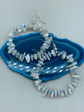Load image into Gallery viewer, These nature-inspired White Moon Stone Chip Beaded Hoop Earrings are the perfect accessory for adding a boho-chic vibe to any look. Crafted with natural white moon stone chips and blue glass beads, these earrings will complete your outfit with the ultimate hippie and shabby-chic feel. Measurements: 1 1/2" length