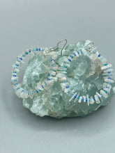 Load image into Gallery viewer, These nature-inspired White Moon Stone Chip Beaded Hoop Earrings are the perfect accessory for adding a boho-chic vibe to any look. Crafted with natural white moon stone chips and blue glass beads, these earrings will complete your outfit with the ultimate hippie and shabby-chic feel. Measurements: 1 1/2" length