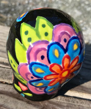 Load image into Gallery viewer, This Mini Day of the Dead Black Ceramic Sugar Skull is a stunning, nature-inspired piece of hand painted art. Featuring elements from a photography I took of a flower floating in a fountain at Grounds for Sculpture, this unique work of art is ideal for honoring memories of those who have passed. Its beautiful mausoleum, statues, and stained glass elements make it the perfect choice for any special occasion. Measurements: H 2 3/4” x W 2” x D 2”