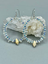 Load image into Gallery viewer, Crafted with natural white moonstone chips, blue glass beads and tiny conch shells, these hoop earrings are a bohemian statement piece. Perfect for nature and beach lovers, they add a touch of shabby chic to any summer look. Measurements: 2" length
