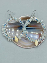 Load image into Gallery viewer, Crafted with natural white moonstone chips, blue glass beads and tiny conch shells, these hoop earrings are a bohemian statement piece. Perfect for nature and beach lovers, they add a touch of shabby chic to any summer look. Measurements: 2" length