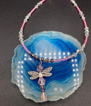 Load image into Gallery viewer, This softy pink and purple choker style necklace with a silver dragonfly pendant is perfect for nature lovers. Glass beads make the necklace adjustable, and it comes with matching dragonfly earrings for a truly magical, fairy princess look. An ideal accessory for summer. Measurements: Necklace is 15 1/2” adjustable up to 18"