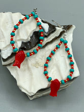 Load image into Gallery viewer, This eye-catching pair of earrings features vibrant fire engine red fish glass beads, accented with small teal, red, and golden glass beads. Each fish bead boasts detailed fins and eyes, creating a bright and captivating piece of jewelry measuring 2" in length.
