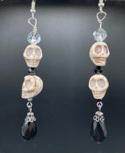 Load image into Gallery viewer, This luxurious design features two large howlite skull beads and a large black teardrop shaped glass bead; perfect for achieving a Chingona, Cabrona, Latina Chicana, Goth, Vampire Goth, Dark Witchy, La Bruja look. This statement jewelry will add a unique touch to any outfit.