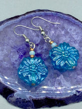 Load image into Gallery viewer, This light blue pressed glass floral bracelet is a sophisticated addition to any summer look. Its iridescent shimmer finish adds a classy touch to its intricate metal wire and lobster claw clasp. Perfect for any nature-inspired wardrobe. Measurements: Bracelet: 8" in length Earrings: 1 1/4" length
