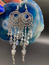 Load image into Gallery viewer, Whimsical Celestial Smiling Crescent Moons Large Chandelier Earrings. Five strands of beautiful clear iridescent glass beads and dangling smiling crescent moon charms. This is perfect for any outfit and will surely stand out. Measurements:  4” in length. Witchy, Whimsical, Goth, Luna Lovers, Crescent Smiling Moons