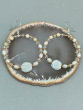 Load image into Gallery viewer, These white floral glass beaded hoop earrings bring a bohemian, shabby-chic, and nature-inspired vibe to any look. Crafted with small iridescent, gold, and white glass beads, they are the perfect accessory for any fashionista who loves beach vibes, summer elements, and chic boho styles. Measurements: 2 1/4" length