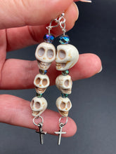 Load image into Gallery viewer, For The Dark Souls Three Howlite Skull Beads Light Blue Iridescent Glass Bead Earrings Dangling Silver Plated Cross Give These Earrings Movement. Chingona, Cabrona, Latina Chicana, Goth, Vampire Goth, Dark Witchy Style. You can dress these up or down, it will definitely give your outfit a unique look.  Measurements: 3 ” in length