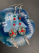 Load image into Gallery viewer, These Southwester Style Silver Feather Light Dainty Beaded Earrings are richly adorned with turquoise, bright red and dark green, and feature silver plated feather charms for a fun, dynamic effect. A perfect match for any Chingona Carbrona, La India Princess, Fierce Goddess Warrior, or Tribal Pattern look. Measurements: 3” in length