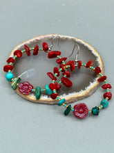 Load image into Gallery viewer, These Bamboo Coral Red Stone Chip earrings are complemented by turquoise and gold glass beading and a shimmery red pressed glass flower charm. The charm's iridescent shimmer finish has subtle hues of gold, purple, blue and pink. Measurements: 2" length