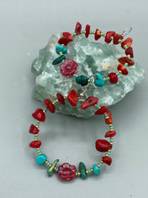 Load image into Gallery viewer, These Bamboo Coral Red Stone Chip earrings are complemented by turquoise and gold glass beading and a shimmery red pressed glass flower charm. The charm's iridescent shimmer finish has subtle hues of gold, purple, blue and pink. Measurements: 2" length