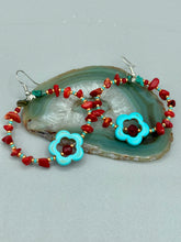 Load image into Gallery viewer, These earrings feature a turquoise magnesite floral bead with a dark red glass bead in the center and artfully beaded with bamboo red coral and turquoise stones. Measurements: 1 3/4" length