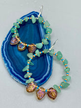 Load image into Gallery viewer, These Aventurine Stone Chip Beaded Hoop Earrings feature natural aventurine stone chips, turquoise, and gold glass beads. The amber-tone pressed glass leaf charm has an iridescent shimmer finish, with subtle accents of gold, purple, blue, and pink. Measurements: 2" length