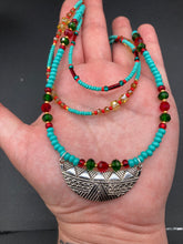 Load image into Gallery viewer, Three strands of Southwestern Style Inspired Adjustable Choker Beaded Necklace features an eye-catching blend of vibrant turquoise, red, green, gold, and yellow glass beads, accented with a wide silver plated tribal pattern pendant. Measurements: Necklace is 15 1/2” adjustable up to 18" in length