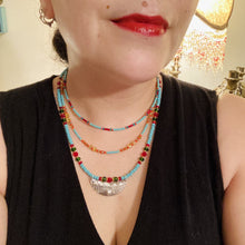 Load image into Gallery viewer, Three strands of Southwestern Style Inspired Adjustable Choker Beaded Necklace features an eye-catching blend of vibrant turquoise, red, green, gold, and yellow glass beads, accented with a wide silver plated tribal pattern pendant. Measurements: Necklace is 15 1/2” adjustable up to 18" in length