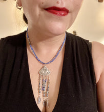 Load image into Gallery viewer, Triangle Illuminati Silver Plated Pendant With Blue And Silver Color Glass Bead Adjustable Necklace.  Mysterious and unique necklace has a very whimsical vibe with a dash of mystery. Contains 5 beaded strands with intricate leaf charms that create movement. This unique look will complete any outfit. Witchy, Gothic, Illuminati, Mysterious versatile style, bold elegant piece of jewelry.  Measurements: Necklace is 16 1/2” adjustable up to 19" in length - pendant is 4” Height with bail