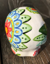 Load image into Gallery viewer, Bring Southwest beauty to any space with this unique ceramic sugar skull art. Hand-painted with bright colors, this piece captures the spirit of Sedona in a Dia de Los Muertos ofrenda. Let this delightful piece evoke the magical beauty of the amazing landscape you'll never forget. H 2 3/4” x W 2” x D 2”