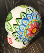 Load image into Gallery viewer, Bring Southwest beauty to any space with this unique ceramic sugar skull art. Hand-painted with bright colors, this piece captures the spirit of Sedona in a Dia de Los Muertos ofrenda. Let this delightful piece evoke the magical beauty of the amazing landscape you'll never forget. H 2 3/4” x W 2” x D 2”