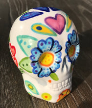 Load image into Gallery viewer, This stunning Mini Dia de Los Muertos Calavera is a one-of-a-kind hand-painted ceramic sugar skull, with an aquatic-inspired color palette. The unique flower on the back of the skull is painted to look like the head of a jellyfish. Display this beautiful piece of art and enjoy the elegance and beauty of its delicate dance. Measurements: H 2 3/4” x W 2” x D 2”