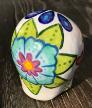 Load image into Gallery viewer, This stunning Mini Dia de Los Muertos Calavera is a one-of-a-kind hand-painted ceramic sugar skull, with an aquatic-inspired color palette. The unique flower on the back of the skull is painted to look like the head of a jellyfish. Display this beautiful piece of art and enjoy the elegance and beauty of its delicate dance. Measurements: H 2 3/4” x W 2” x D 2”
