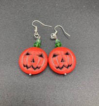Load image into Gallery viewer, These cute set of Jack O Lantern large orange pumpkin bead earrings really captures the essence of Halloween. I added green glass beads to bring a pop of shimmer and color.  Measurements: 1 3/4 ” in length
