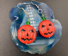 Load image into Gallery viewer, These cute set of Jack O Lantern large orange pumpkin bead earrings really captures the essence of Halloween. I added green glass beads to bring a pop of shimmer and color.  Measurements: 1 3/4 ” in length