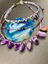 Load image into Gallery viewer, The Genuine Amethyst Natural Gemstone Adjustable Chocker Style Glass Beaded Necklace features vibrant violet and white tones. Its unique draped beading creates a beautiful style with a series of short strands of glass beads for movement and a longer strand with a multitude of amethyst nugget beads. The collar necklace hangs gracefully along the neck and chest, making it a dream come true for violet lovers.  Measurements:  Necklace is 15” in length adjustable to 18" in length
