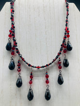 Load image into Gallery viewer, Dark Goth, Vampire Goth, Misfits - Black and Red Choker Style Glass Beaded Necklace. Large Tear Drop Black Hanging Glass Beads. Contains a mixture of shape and color glass beads to give it complexity and depth to the look. Necklace beautifully drapes down your neck. Dark, beautiful, unique gift for the bold. Necklace is 16” adjustable up to 18" - teardrop hanging beads are 2” Height Earrings: 2" in length