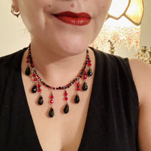 Load image into Gallery viewer, Dark Goth, Vampire Goth, Misfits - Black and Red Choker Style Glass Beaded Necklace. Large Tear Drop Black Hanging Glass Beads. Contains a mixture of shape and color glass beads to give it complexity and depth to the look. Necklace beautifully drapes down your neck. Dark, beautiful, unique gift for the bold. Necklace is 16” adjustable up to 18" - teardrop hanging beads are 2” Height Earrings: 2" in length