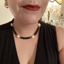 Load image into Gallery viewer, This Cocktail Chic Long Beaded Necklace is a unique piece that can be styled in different ways. Crafted with black flat matte glass beads for a luxurious look, the necklace is complemented by small and large white rose beads for contrast. The intricate petal details give the piece an extra special touch. This set is a simple and elegant pieces, very versatile looks and comes with a pair of matching earrings. Perfect cocktail chic attire, fancy wedding necklace, a minimalist look.