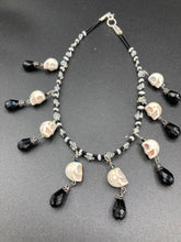 Load image into Gallery viewer, Black And White Vampire Goth Skulls Choker Style Necklace, Skully Witchy Vibe, Goth Dark Souls Jewelry, Day Of The Dead, Dia De Los Muertos, Howlite Skull Beads Black And Silver Glass BeadsThis statement necklace radiates a dark, shimmering aesthetic with two strands of glass beads connected through double-hole silver and black beads to create a collar shape. These dangling skulls beads are acompanied by black teardrop glass beads enable the piece to flow elegantly and express a bold, fierce look.