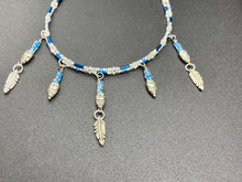 Load image into Gallery viewer, Silver And Blue Wise Owl Charm Choker Style Glass Beaded Necklace. Whimsical and elegant necklace has two different styles of tiny cute owls with silver plated feathers. Some say wearing an owl pendant around your neck is just want you need for a better connection to your intuition. Owls symbolize wisdom, the wisdom that comes to prevent hasting rushing or being impulsive. Necklace comes with matching earrings, necklace is 16” adjustable up to 18" in length - hanging owls and feather pendant are 2” Height