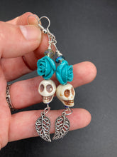 Load image into Gallery viewer, Frida Kahlo Inspired Earrings, Howlite Skull And Turquoise Quartize Floral Beads. This beautifully and elegant set of earrings captures Frida Kahlo's signature floral crown on her head. Dangling silver plated intricate leaf at the bottom to give these earrings some movement. These are a beautiful piece of jewelry to wear for inspiration or a great Dia De Los Muertos jewelry piece. Chingona, Cabrona, Latina Chicana, Goth, Vampire Goth, Dark Witchy Style. 2 ” in length
