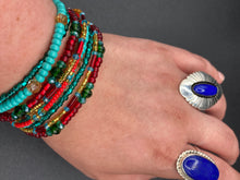 Load image into Gallery viewer, Vibrant And Enchanting Southwest Style Jewelry. This stunningly bold statement piece contains nine beaded strands full of variant turquoise, bright and dark reds and greens, golds and yellows. I created this beautiful jewelry piece by using a wide variety of different bead shapes from large and small round, round tubes, and squares. Measurements: 7 1/2" in length