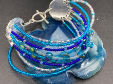 Load image into Gallery viewer, This Ocean Blue Waves Nine Stands Glass Beaded Chunky Wide Bracelet is the ideal accessory for any summer seaside look. Measurements: 8" in length