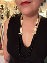 Load image into Gallery viewer, This two-strand necklace features a selection of natural black obsidian stone, hematite, bone, and glass beads. This neutral-hued accessory enhances any ensemble. Measurements: Necklace is 29” in length, can be adjusted up to 30" in length
